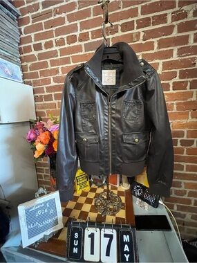 Brown faux-leather bomber jacket with four front utility pockets and ribbed